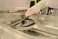 A semiconductor wafer being removed from processing equipment